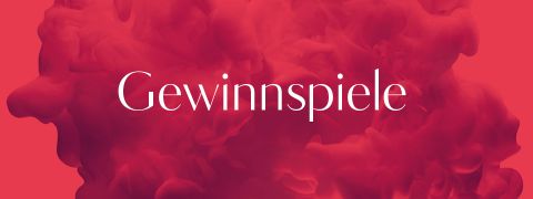 L'image montre le mot « Gewinnspiele » en blanc, centré sur un fond abstrait et enfumé en rouge et rose.