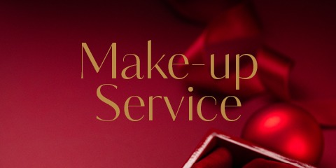 Une image en rouge avec les mots « Service de maquillage » en élégante écriture dorée. En arrière-plan, on aperçoit un ruban rouge flou et un ornement, ainsi qu'une partie d'une boîte ouverte dans le coin inférieur droit.