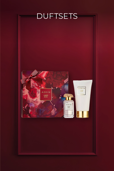 Coffret cadeau de parfum dans un cadre rouge foncé avec une boîte à motifs floraux, un petit flacon de parfum et un tube blanc avec un bouchon doré. En haut, il est écrit « Coffrets de parfums » en blanc.