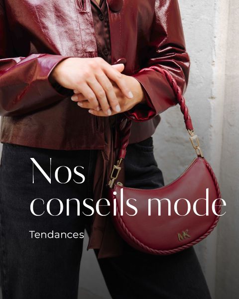 Une personne portant une veste bordeaux brillante et un pantalon noir tient un sac à main Michael Kors bordeaux assorti. Le texte français sur l'image est : Nos conseils mode - Tendances 2025.