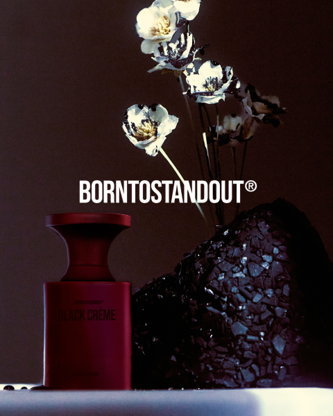 Une bouteille blanche portant l'inscription "DIRTY MILK" repose sur une surface réfléchissante avec un dégradé rouge chaud. En dessous, en gras rouge, on peut lire "BORNTOSTANDOUT®".
