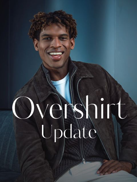 Un homme souriant dans une surchemise marron et un t-shirt blanc est assis sur un canapé. Le texte sur l'image dit : « Mise à jour de la surchemise ».