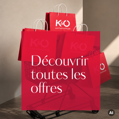 Dans un caddie se trouvent plusieurs sacs rouges Kastner & Öhler. Le texte français est : « Découvrir toutes les offres. ».