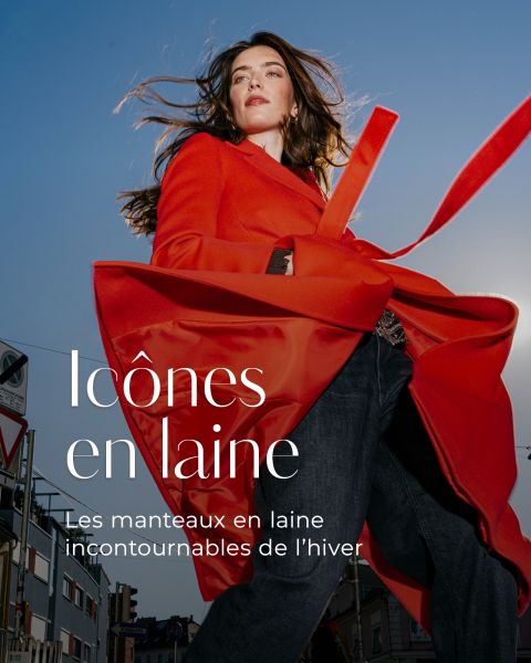 Une femme porte un manteau de laine rouge vif avec un jean foncé ; au-dessus se trouve le texte « Icônes en laine : Les manteaux de laine incontournables de l'hiver. »